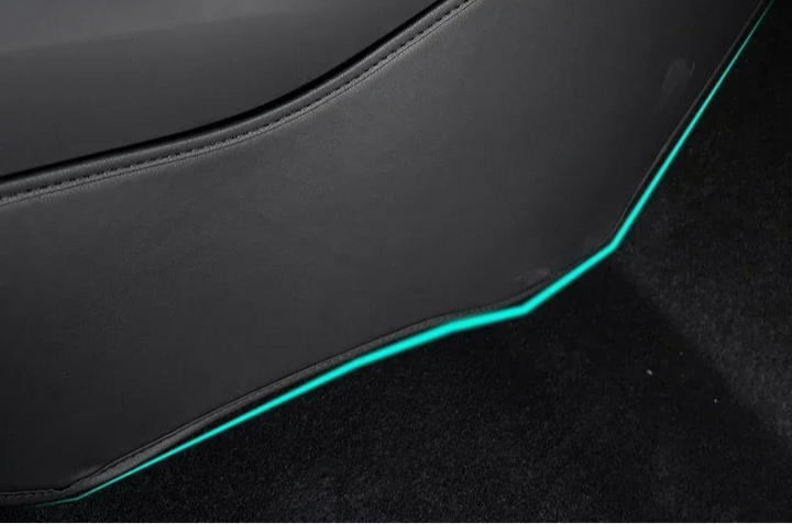Side Defense Kick Pad for Tesla Model 3+ highlighted in blue, placed on the vehicle's interior door panel.