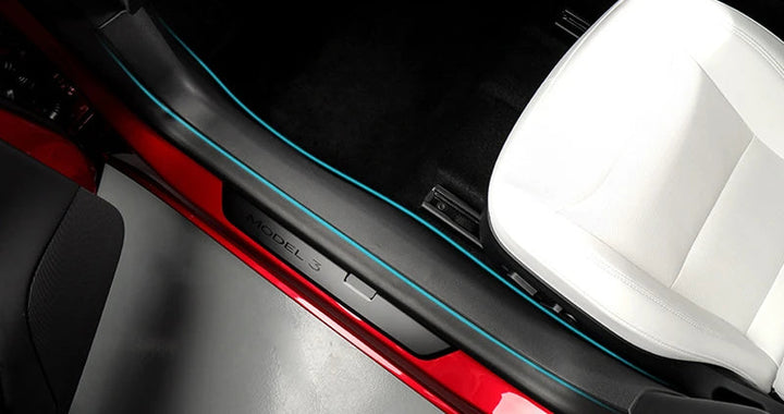 A set of black TPE door sill pads designed for the Tesla Model 3, displayed in various positions around the vehicle's door threshold.