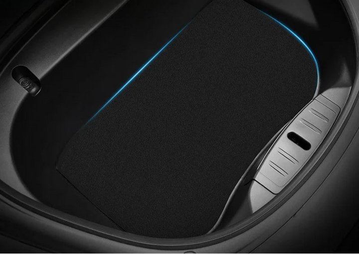 A black flocking trunk mat designed for the Tesla Model 3, placed inside the trunk of the car highlighting its fit and design.