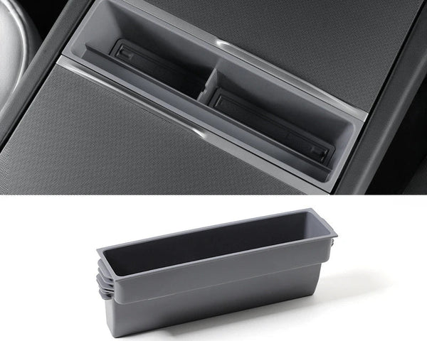 A black or gray central control storage box for Tesla Model 3+ with a label indicating it is a new item for the Tesla Model 3+ Armrest Card Mobile Phone Storage Case.
