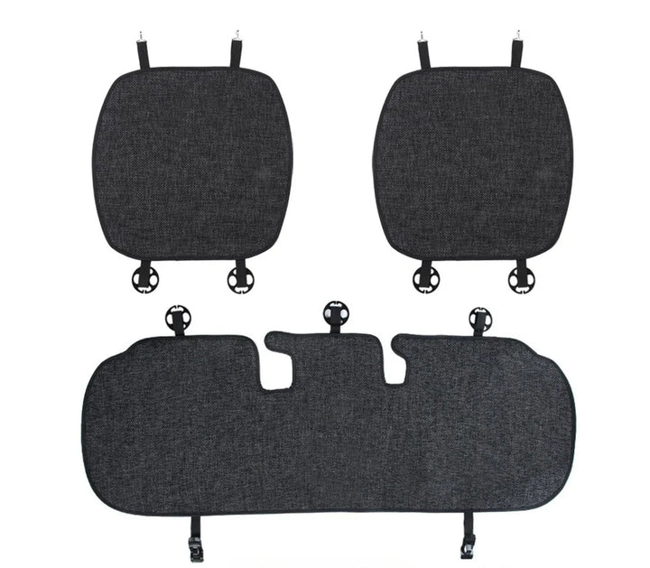 Flax seat pad covers installed on the front and rear seats of a Tesla Model Y, showcasing the product's design and fit.