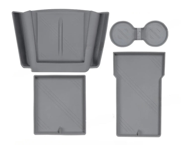 Set of silicone central control storage pads for Tesla Model 3, including a water cup mat, armrest box lower storage mat, and wireless charging pad with side pockets.
