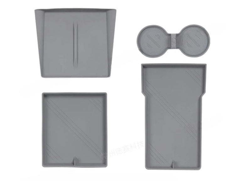 Set of silicone central control storage pads for Tesla Model 3, including a water cup mat, armrest box lower storage mat, and wireless charging pad with side pockets.