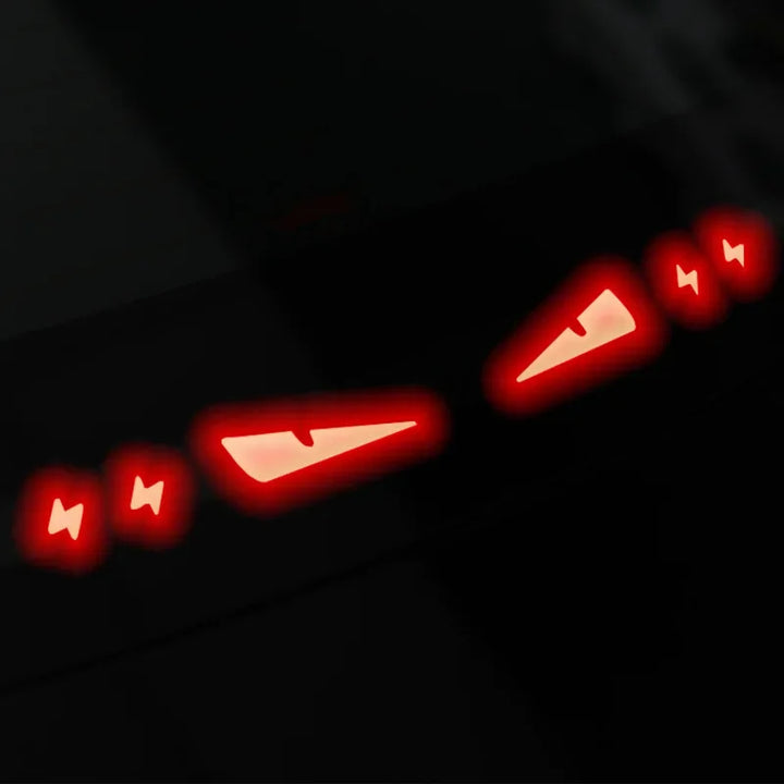 A collage of images showing brake light stickers for Tesla Model 3/3+ Highland. The stickers are displayed in red color with text and symbols, and are shown in various states of application including the packaging, the car trunk, and the vehicle itself.