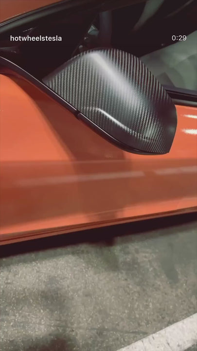 Carbon fiber mirror cap on orange car